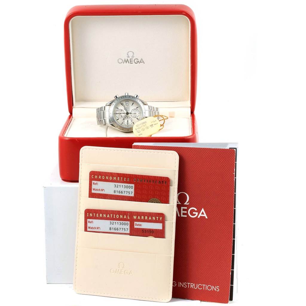 The Omega Speedmaster 3211.30.00 Men
s Stainless Steel Silver Dial 3211.30.00 Men
s Stainless Steel Silver Dial watch is pictured in an open case with warranty cards and instruction manuals beside it.