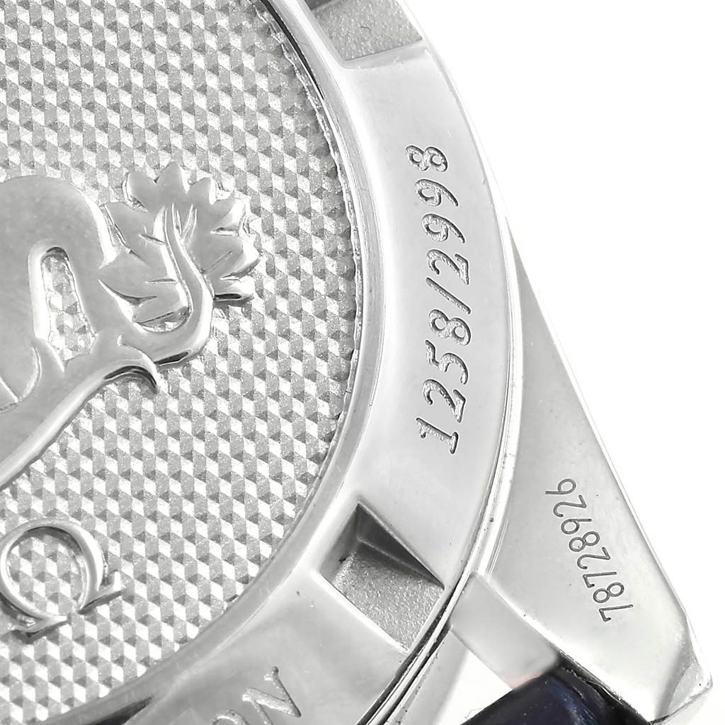 The image shows a close-up of the case back of an Omega Speedmaster 311.33.40.30.02.001 Men's Stainless Steel Silver Dial 311.33.40.30.02.001 Men's Stainless Steel Silver Dial watch, featuring engravings and textured detailing.