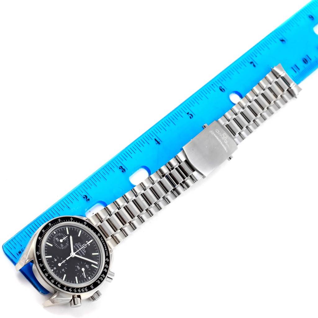 The image shows the Omega Speedmaster 3539.50.00 Men
s Stainless Steel Black Dial 3539.50.00 Men
s Stainless Steel Black Dial watch face, crown, and metal bracelet with a measuring ruler beside it.