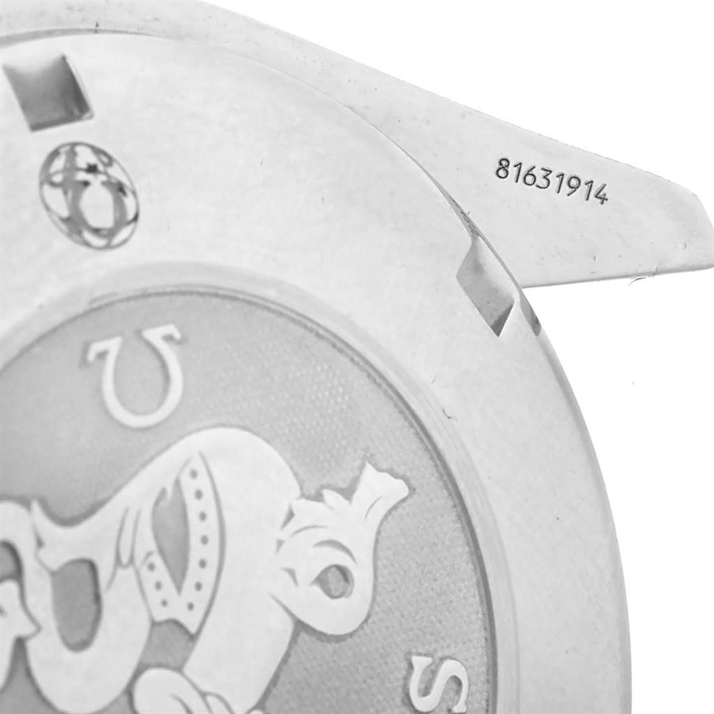 The image shows a close-up of the Omega Speedmaster 3220.50.00 Men
s Stainless Steel Black Dial 3220.50.00 Men
s Stainless Steel Black Dial
s caseback, including the serial number and part of the engraved logo.