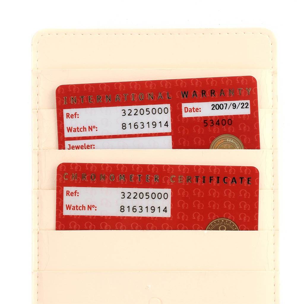 Visible are the International Warranty and Chronometer Certificate cards for an Omega Speedmaster 3220.50.00 Men
s Stainless Steel Black Dial 3220.50.00 Men
s Stainless Steel Black Dial watch.