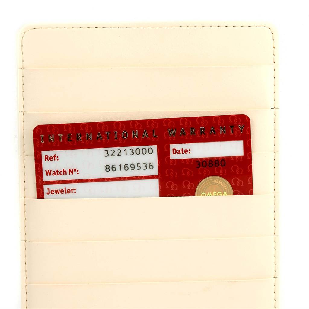 The image shows an international warranty card for the Omega Speedmaster 3221.30.00 Men's Stainless Steel Silver Dial 3221.30.00 Men's Stainless Steel Silver Dial watch, inserted in a beige card holder. 