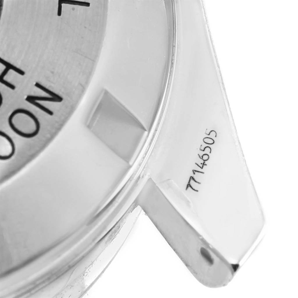 The image shows a macro shot of the casing and part of the bezel of an Omega Speedmaster 3570.50.00 Men's Stainless Steel Black Dial 3570.50.00 Men's Stainless Steel Black Dial watch, highlighting the serial number.