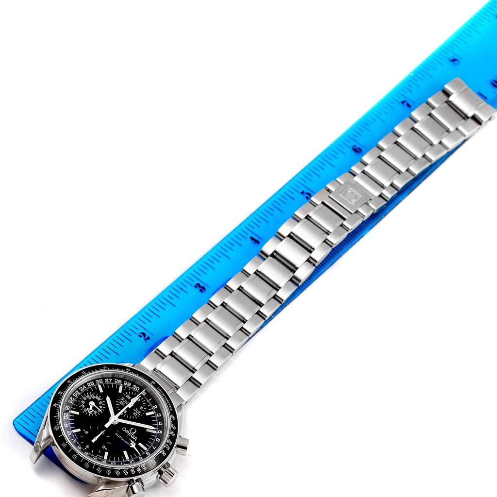 The image shows an Omega Speedmaster 3520.50.00 Men
s Stainless Steel Black Dial 3520.50.00 Men
s Stainless Steel Black Dial watch from a top-down angle, highlighting its bracelet and part of the dial, next to a blue ruler.