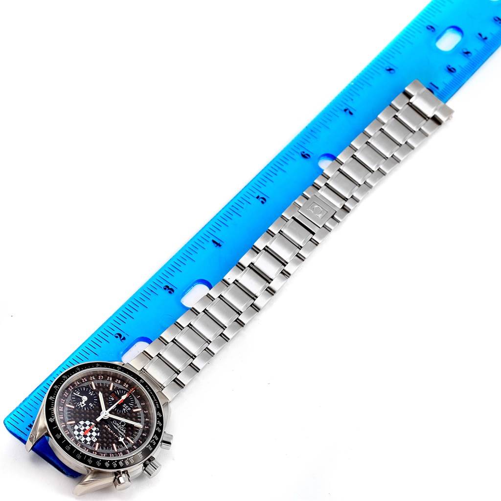 The Omega Speedmaster 3529.50.00 Men
s Stainless Steel Black Dial 3529.50.00 Men
s Stainless Steel Black Dial watch is shown at an angle, displaying the face, crown, and bracelet against a blue ruler.