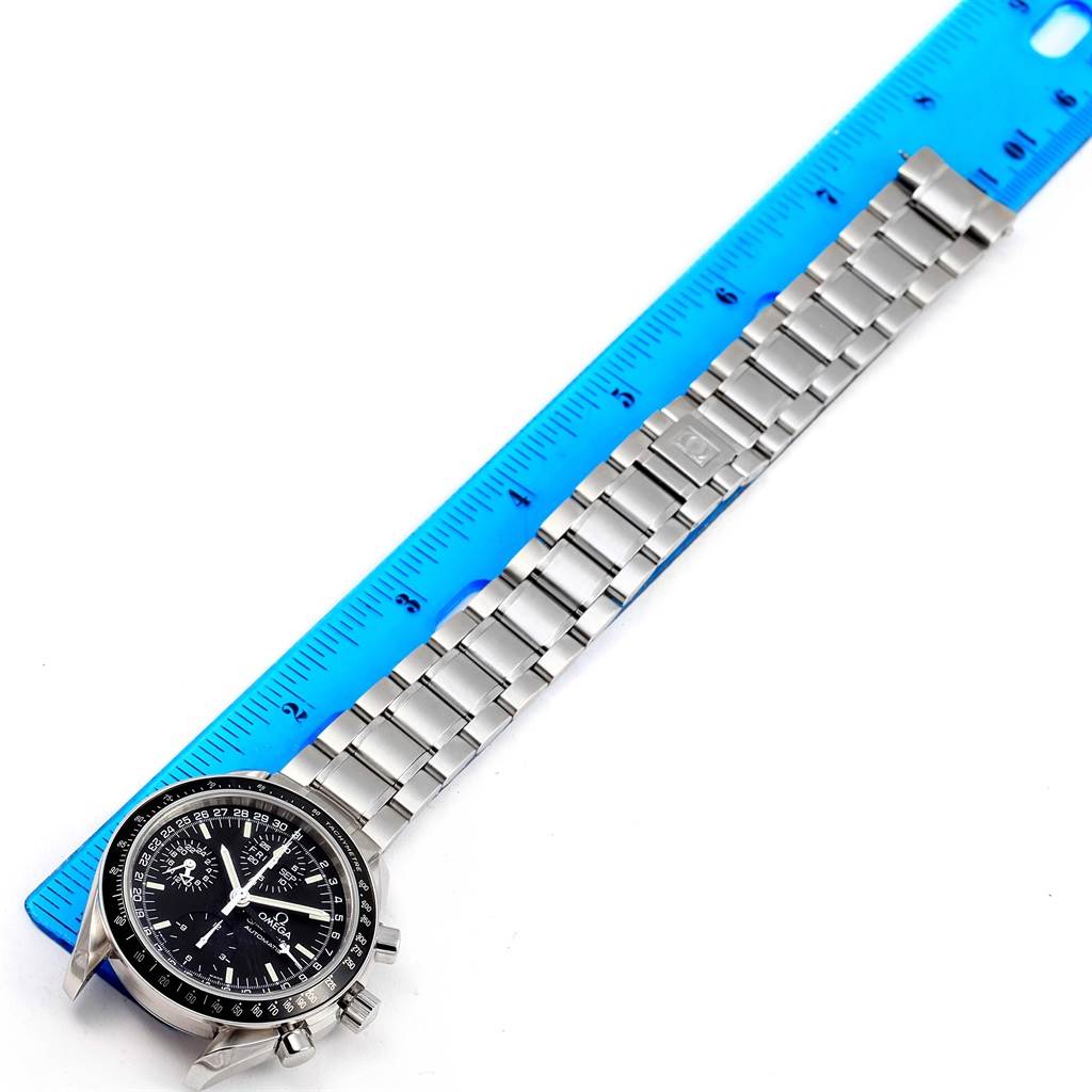 The Omega Speedmaster 3520.50.00 Men
s Stainless Steel Black Dial 3520.50.00 Men
s Stainless Steel Black Dial watch is shown laid flat with its stainless steel bracelet alongside a blue ruler for measurement.