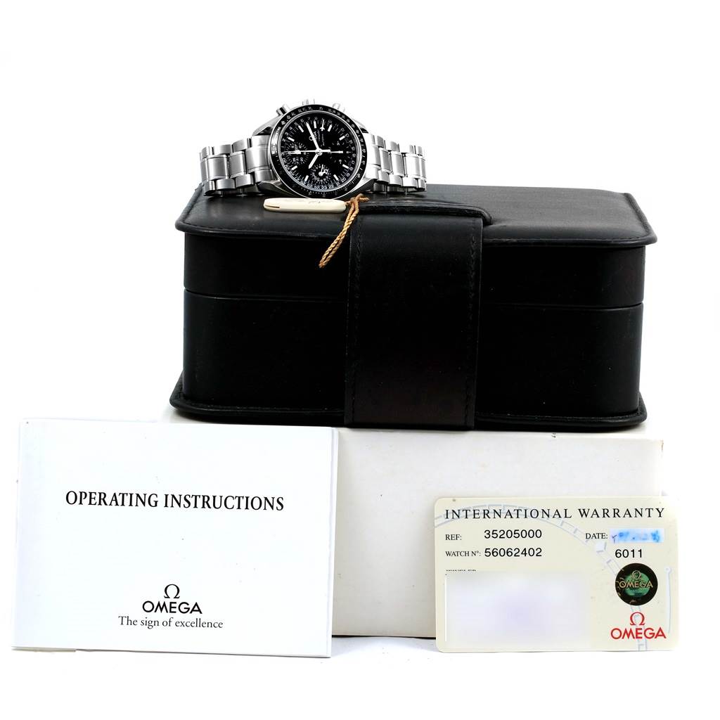 The image shows an Omega Speedmaster 3520.50.00 Men
s Stainless Steel Black Dial 3520.50.00 Men
s Stainless Steel Black Dial watch laid on a black case, along with operating instructions and an international warranty card.
