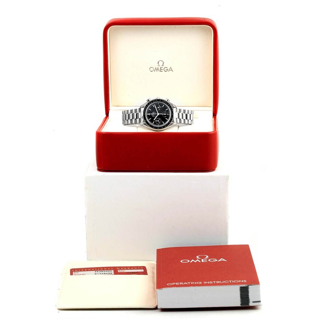 This image shows an Omega Speedmaster 3539.50.00 Men
s Stainless Steel Black Dial 3539.50.00 Men
s Stainless Steel Black Dial watch in its box, along with the warranty card and operating instructions.