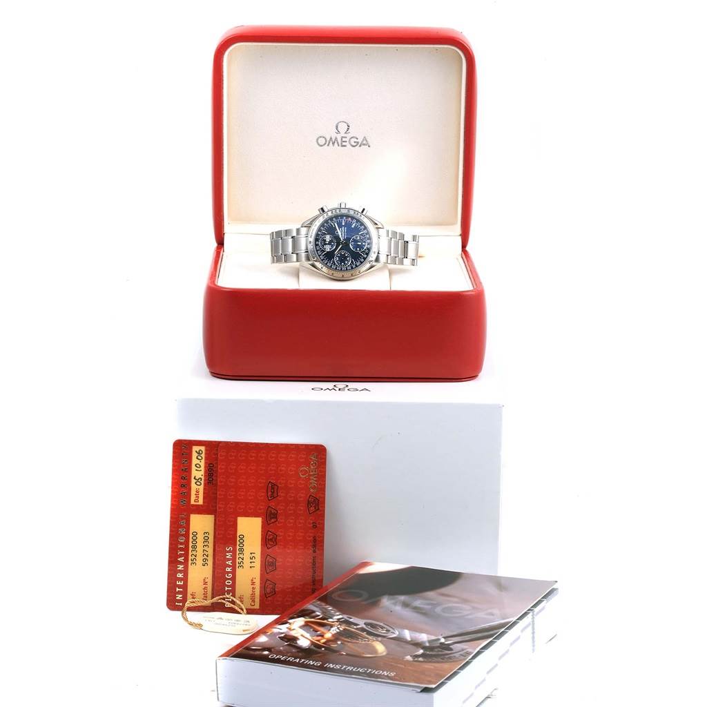 The Omega Speedmaster 3523.80.00 Men
s Stainless Steel Blue Dial 3523.80.00 Men
s Stainless Steel Blue Dial watch is shown front-facing in a red box, with warranty cards and a manual placed below it.