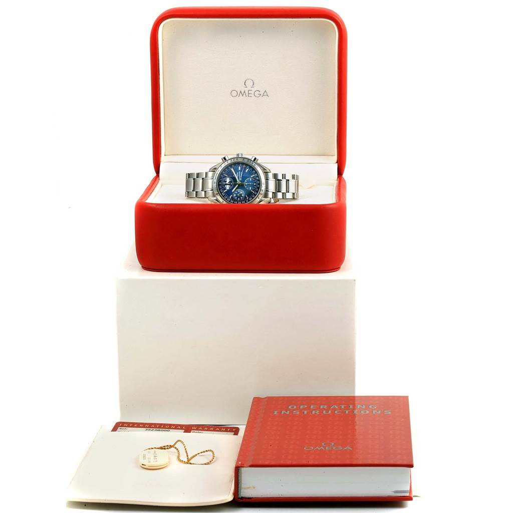 The Omega Speedmaster 3523.80.00 Men
s Stainless Steel Blue Dial 3523.80.00 Men
s Stainless Steel Blue Dial watch is displayed frontally in an open case, with operating instructions, warranty, and a tag.