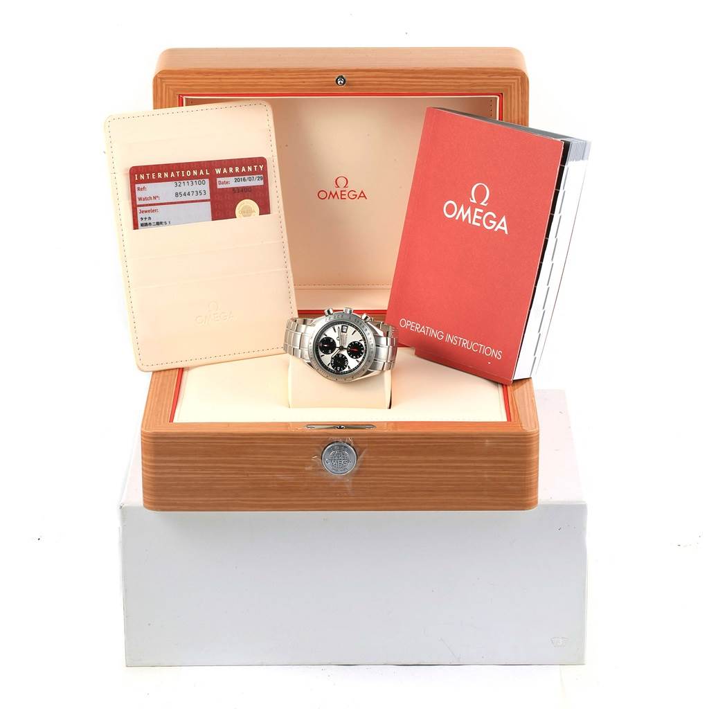 The image shows a front view of an Omega Speedmaster 3211.31.00 Men
s Stainless Steel Silver Dial 3211.31.00 Men
s Stainless Steel Silver Dial watch, its box, warranty card, and operating instructions.