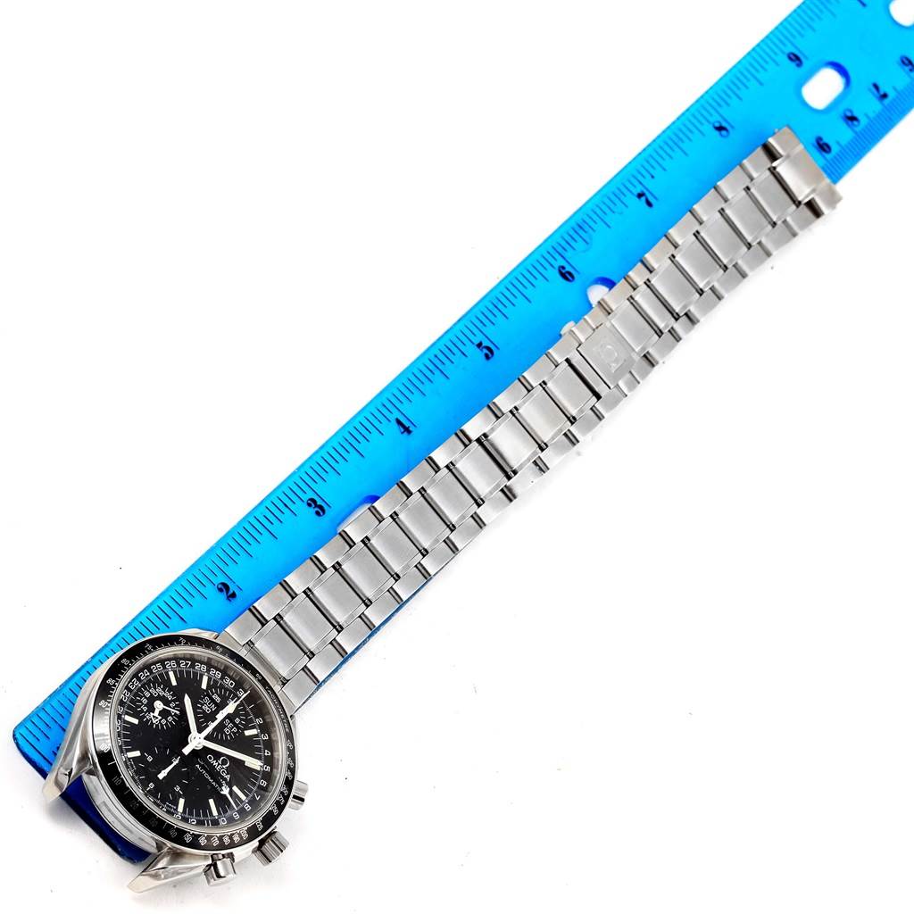 The image shows an Omega Speedmaster 3520.50.00 Men
s Stainless Steel Black Dial 3520.50.00 Men
s Stainless Steel Black Dial watch with a stainless steel bracelet placed next to a blue ruler for measurement.