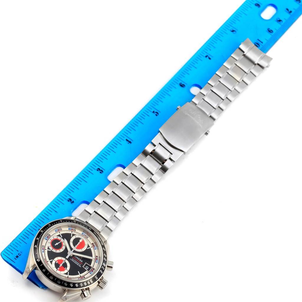 The image shows an Omega Speedmaster 3210.52.00 Men
s Stainless Steel Black Dial 3210.52.00 Men
s Stainless Steel Black Dial watch laid flat next to a ruler, displaying its face and metal bracelet.