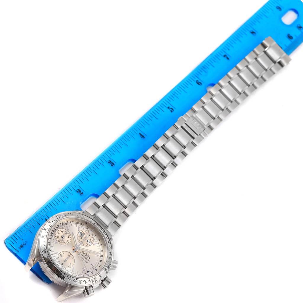 The image shows an Omega Speedmaster 3523.30.00 Men
s Stainless Steel Silver Dial 3523.30.00 Men
s Stainless Steel Silver Dial watch laid flat for measurement alongside a blue ruler.