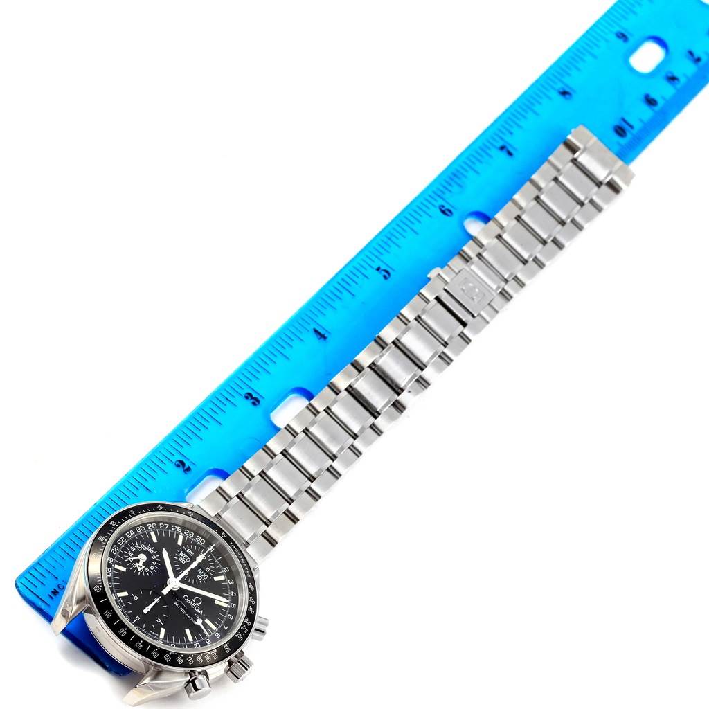 The Omega Speedmaster 3520.50.00 Men
s Stainless Steel Black Dial 3520.50.00 Men
s Stainless Steel Black Dial watch is shown from an angled top view, displaying the face, bezel, and metal bracelet, measured against a blue ruler.