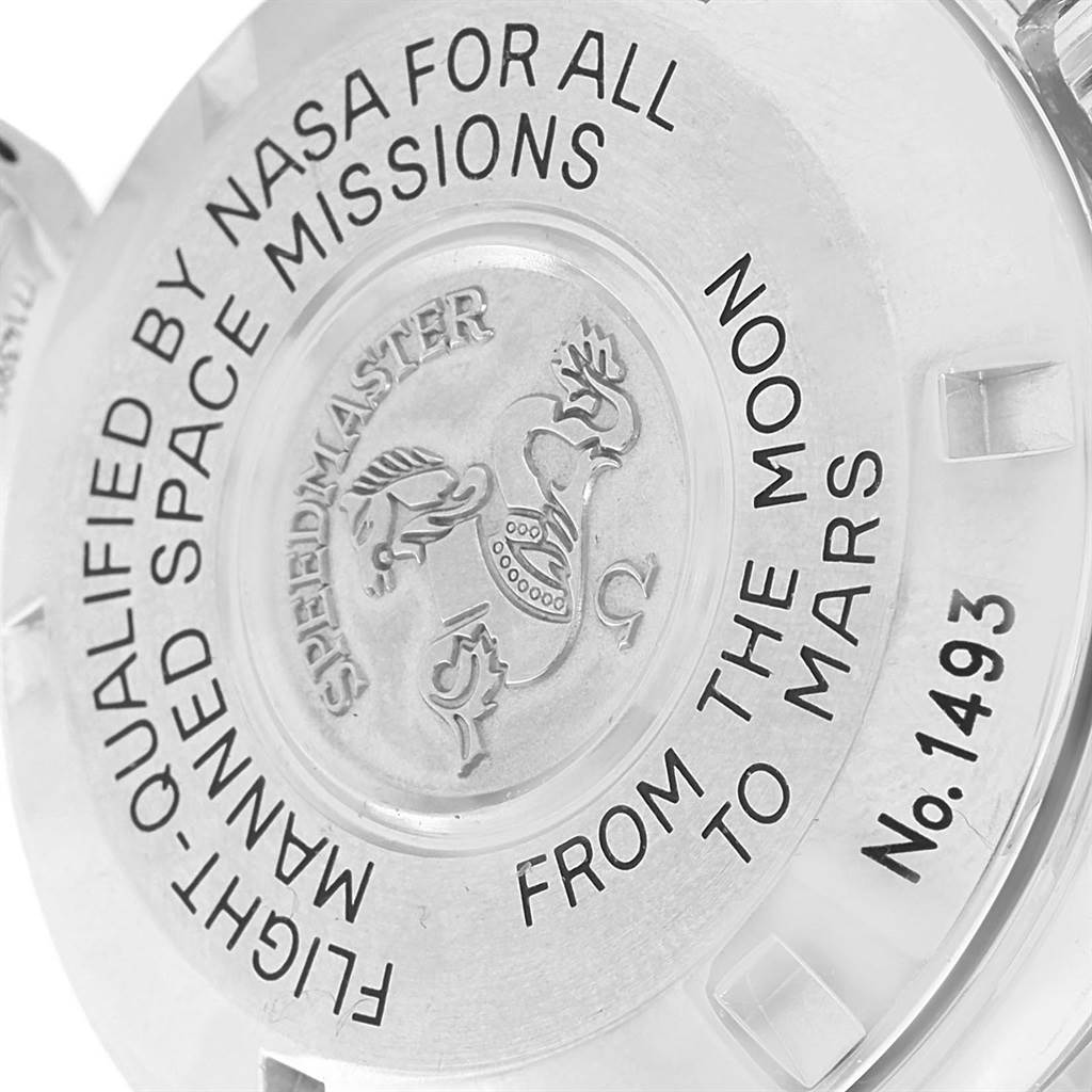 This image shows the engraved case back of an Omega Speedmaster 3577.50.00 Men's Stainless Steel Black Dial 3577.50.00 Men's Stainless Steel Black Dial watch from an oblique angle.