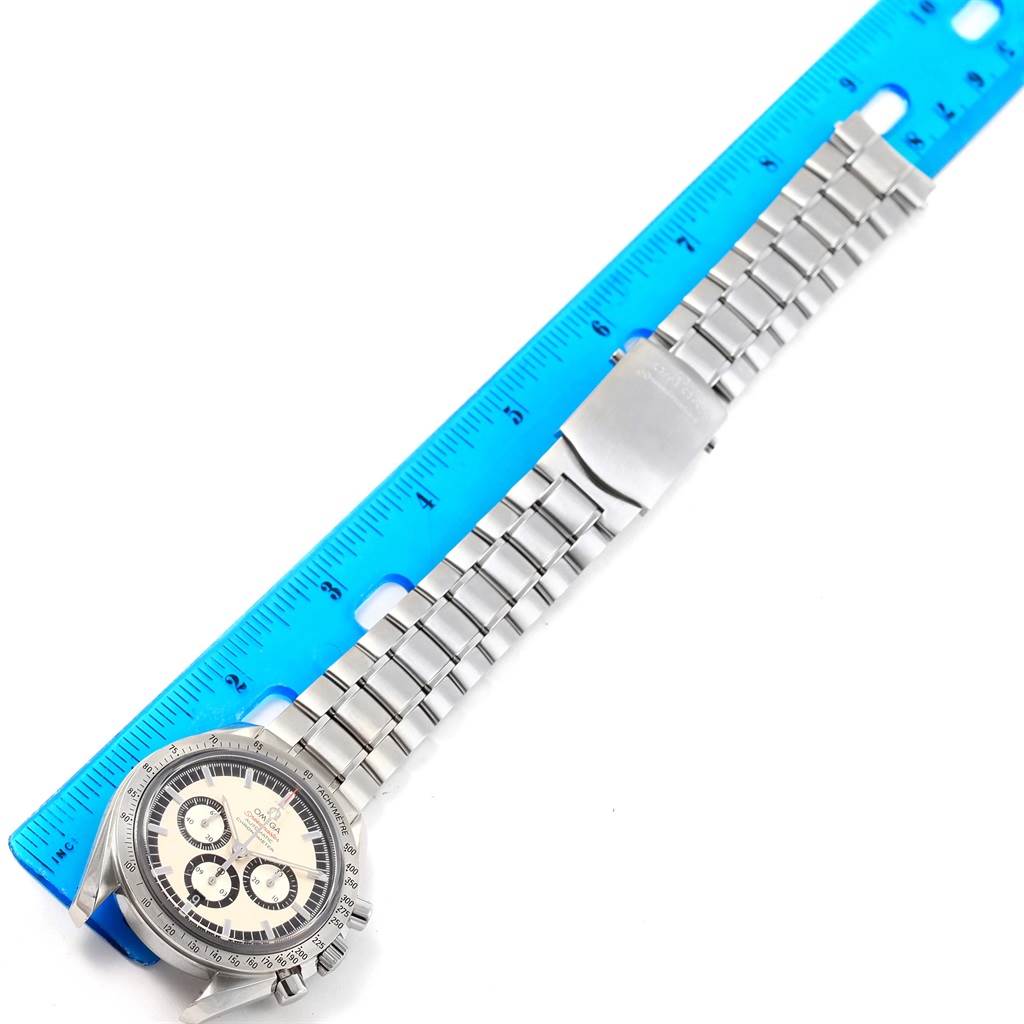 The Omega Speedmaster 3506.31.00 Men's Stainless Steel Silver Dial 3506.31.00 Men's Stainless Steel Silver Dial watch is shown from a top view, with its face, bezel, bracelet, and clasp visible, next to a ruler.