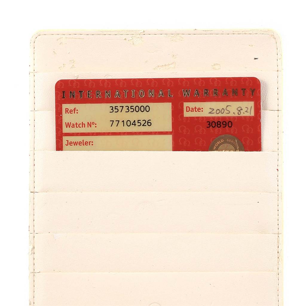 The image shows an international warranty card for an Omega Speedmaster 3573.50.00 Men
s Stainless Steel Black Dial 3573.50.00 Men
s Stainless Steel Black Dial watch, partially inserted in a white cardholder.