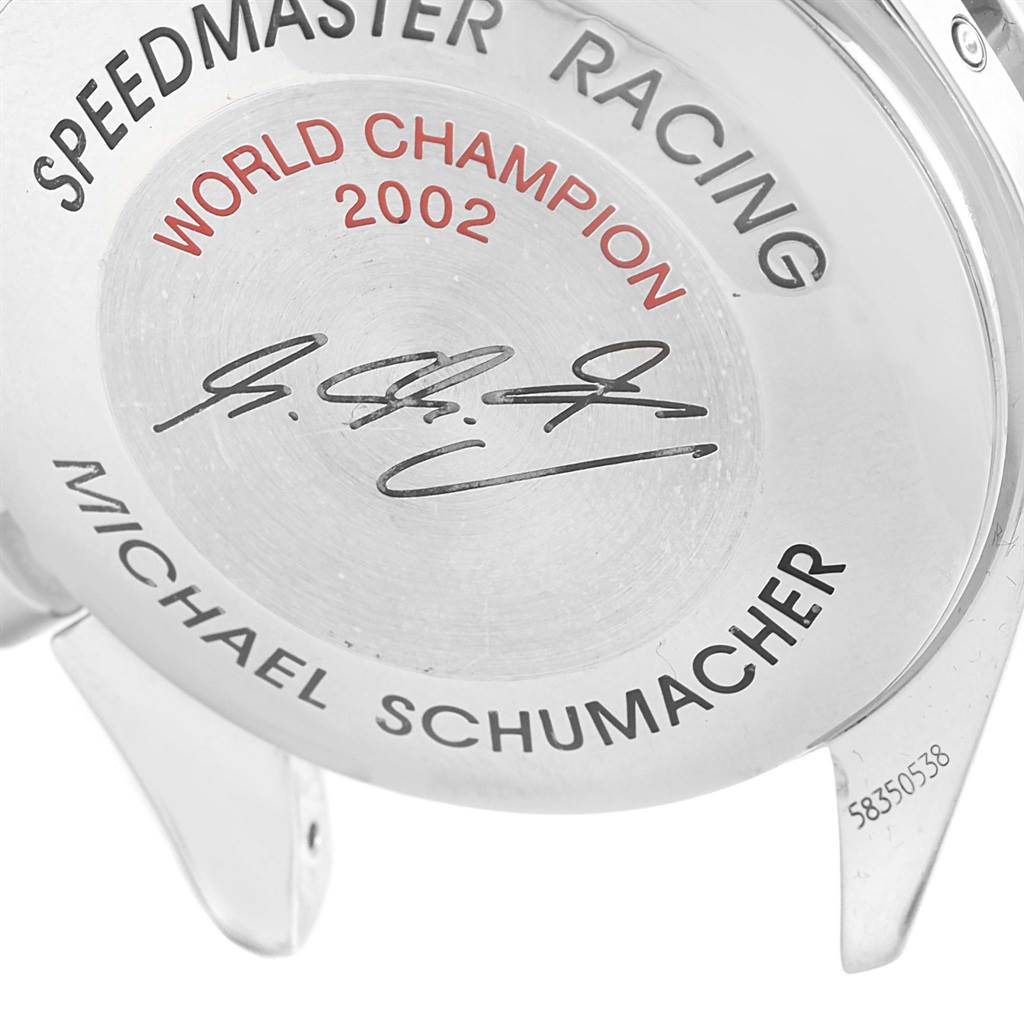 The image shows the back of an Omega Speedmaster 3529.50.00 Men
s Stainless Steel Black Dial 3529.50.00 Men
s Stainless Steel Black Dial Racing watch, including inscriptions for "World Champion 2002" and "Michael Schumacher."