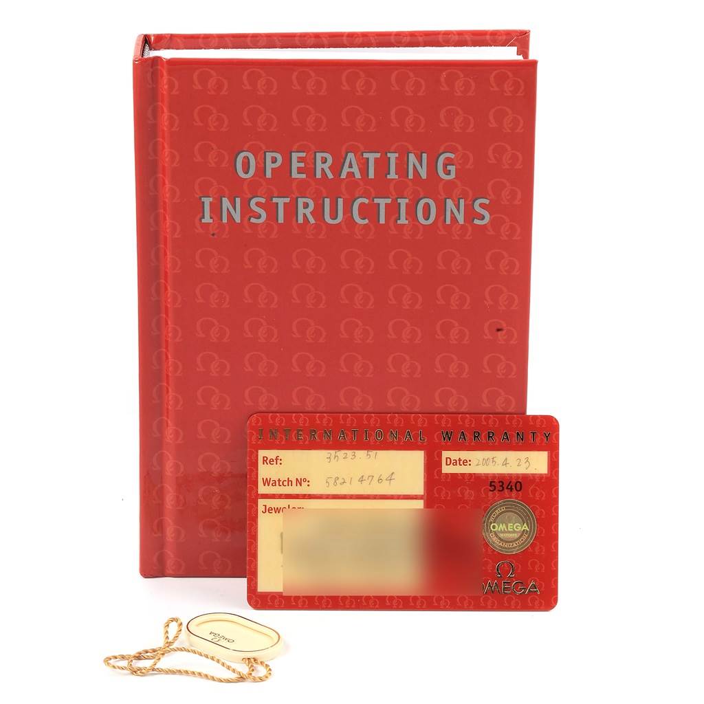 The image shows the operating instructions, the international warranty card, and a tag for the Omega Speedmaster 3523.51.00 Men
s Stainless Steel Black Dial 3523.51.00 Men
s Stainless Steel Black Dial watch.