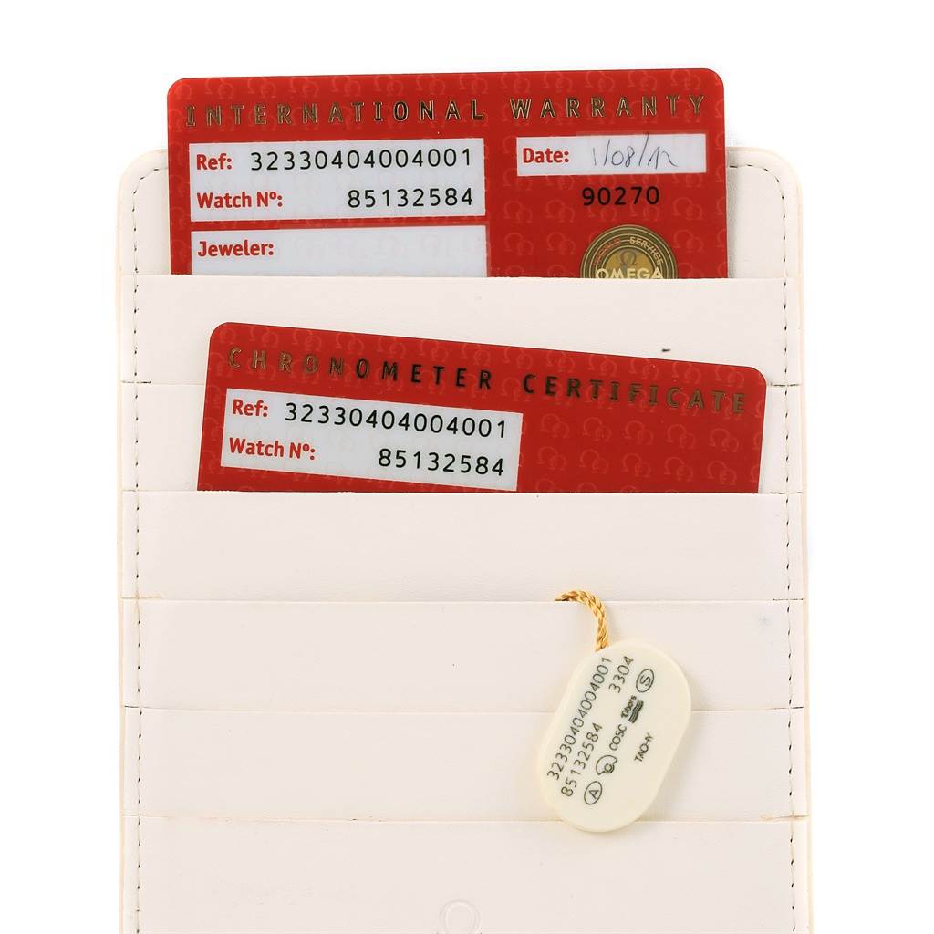 The image shows an Omega Speedmaster 323.30.40.40.04.001 Men
s Stainless Steel White Dial 323.30.40.40.04.001 Men
s Stainless Steel White Dial
s warranty and chronometer certificate cards in a white cardholder.