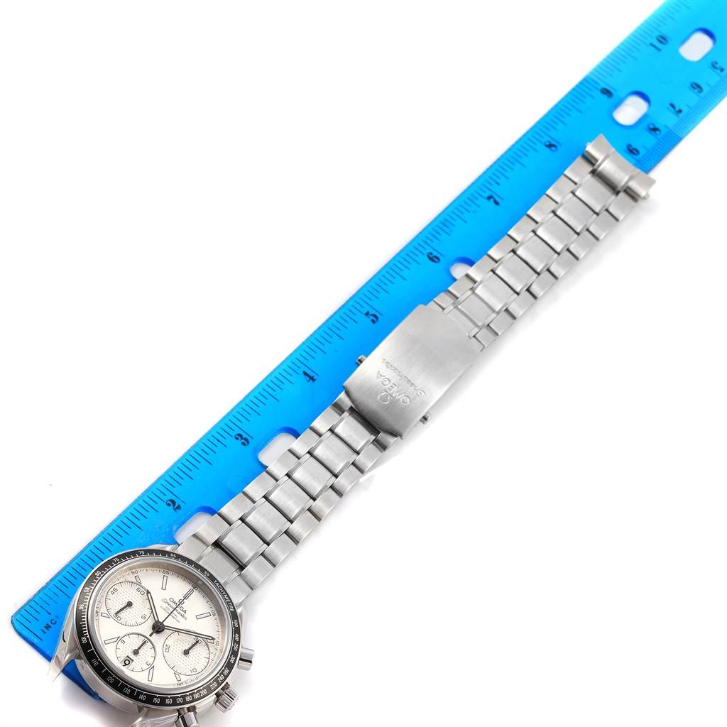 The image shows an Omega Speedmaster 326.30.40.50.02.001 Men
s Stainless Steel Silver Dial 326.30.40.50.02.001 Men
s Stainless Steel Silver Dial watch laid flat with its face, bracelet, and clasp visible next to a blue ruler for scale.