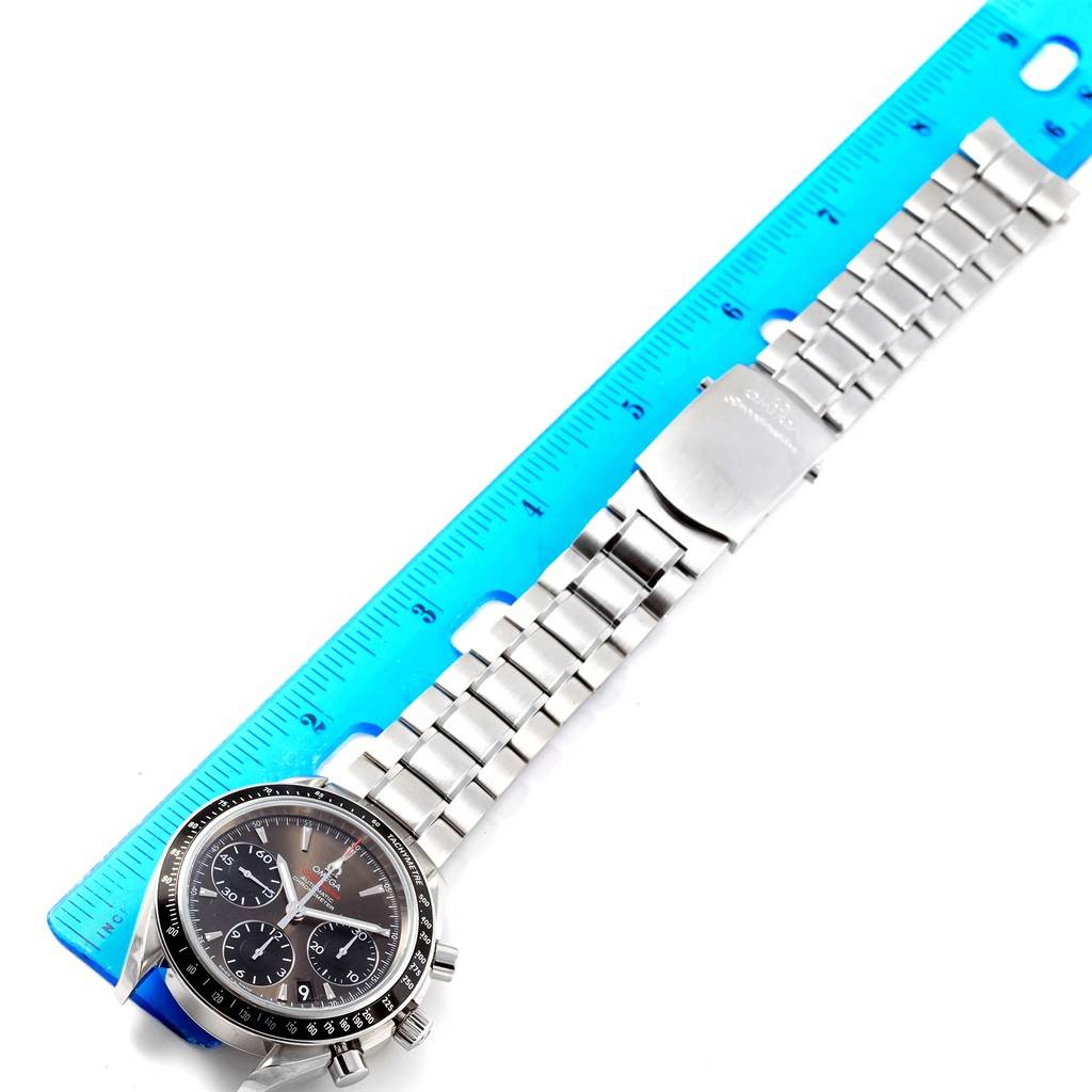The Omega Speedmaster 323.30.40.40.06.001 Men's Stainless Steel Grey Dial 323.30.40.40.06.001 Men's Stainless Steel Grey Dial watch is shown flat with a ruler for scale, displaying the face, band, and clasp.