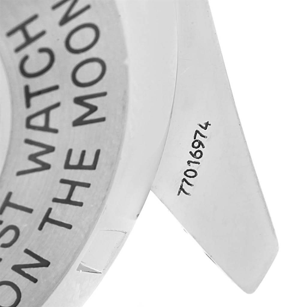 This image shows a close-up of the case back and lug of an Omega Speedmaster 3570.50.00 Men
s Stainless Steel Black Dial 3570.50.00 Men
s Stainless Steel Black Dial watch with part of its engraving visible.