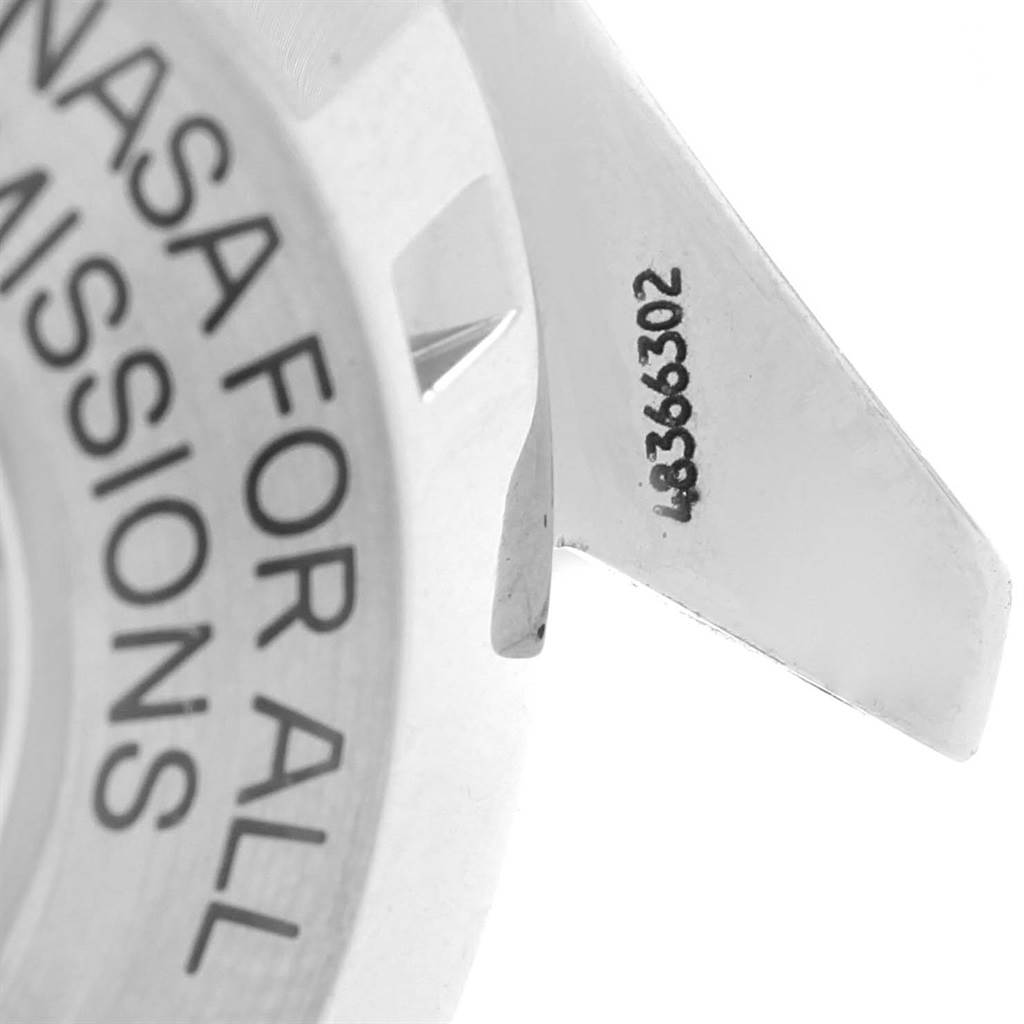 This image shows a close-up of the case back and lug of an Omega Speedmaster 3570.50.00 Men
s Stainless Steel Black Dial 3570.50.00 Men
s Stainless Steel Black Dial watch, including part of the engraved text and serial number.