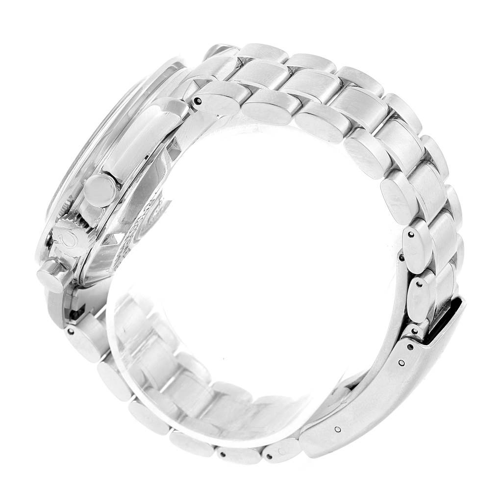 The image shows a side angle of the Omega Speedmaster Men
s Stainless Steel Silver Dial Men
s Stainless Steel Silver Dial watch, highlighting the metal bracelet and part of the case with its crown and pushers.