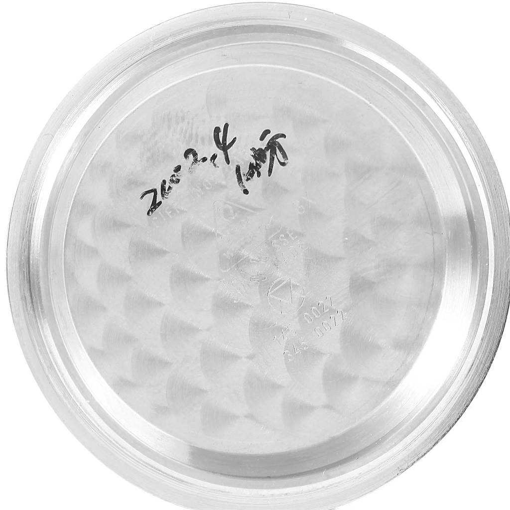 This image shows the inside of the case back of an Omega Speedmaster Men
s Stainless Steel Silver Dial Men
s Stainless Steel Silver Dial watch, viewed from a top-down angle.