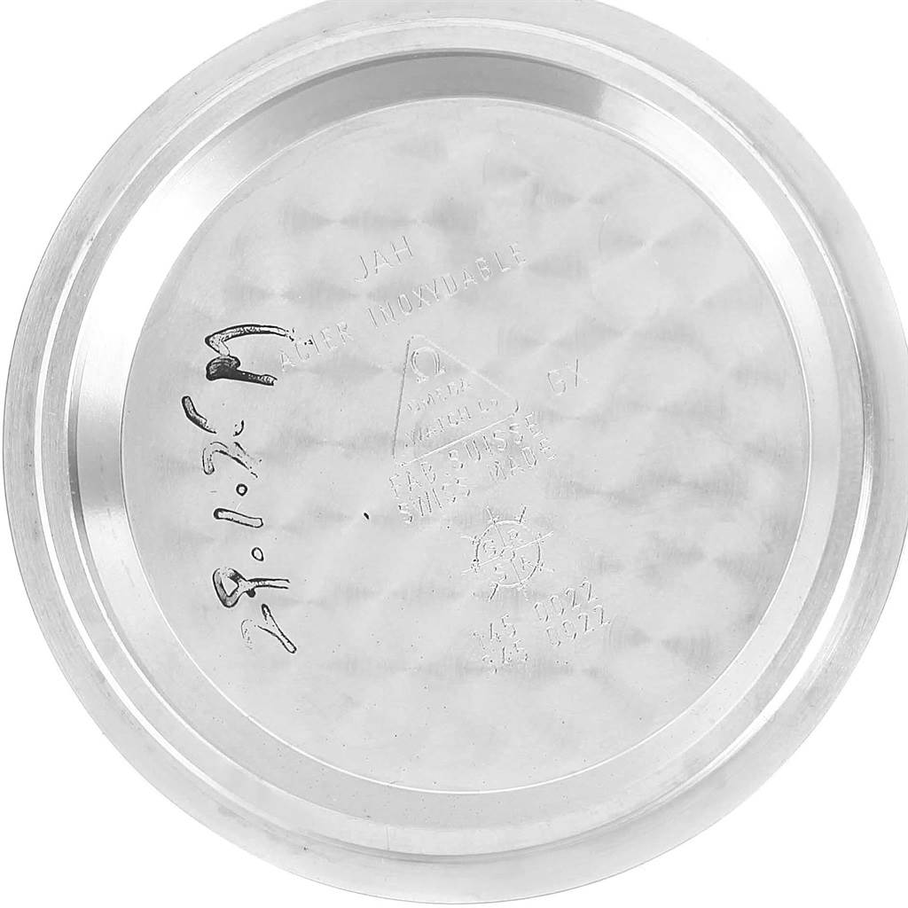 The image shows the inner side of the case back of an Omega Speedmaster Men
s Stainless Steel Black Dial Men
s Stainless Steel Black Dial watch, displayed in a flat, overhead view.