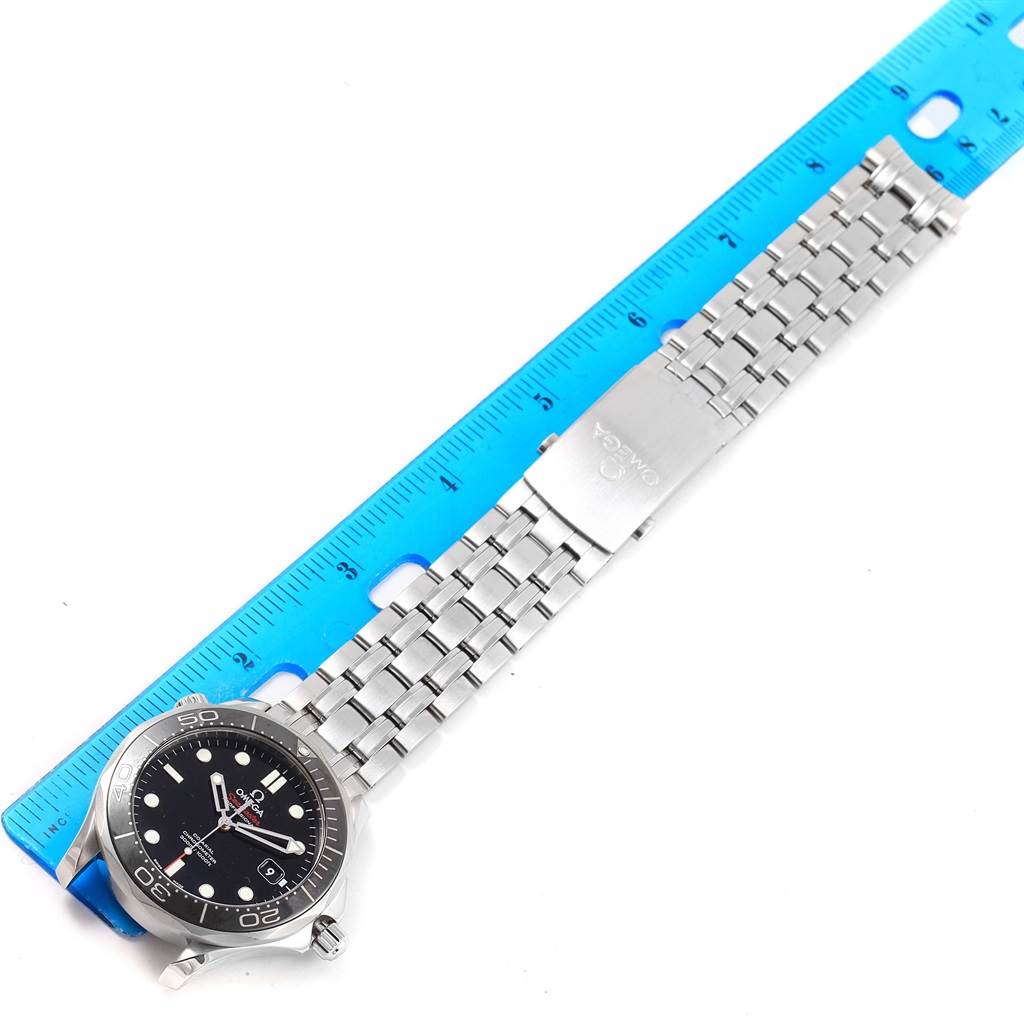 An Omega Speedmaster 212.30.41.20.01.003 Men's Stainless Steel Black Dial 212.30.41.20.01.003 Men's Stainless Steel Black Dial watch is shown flat with a stainless steel bracelet beside a blue ruler for measurement.