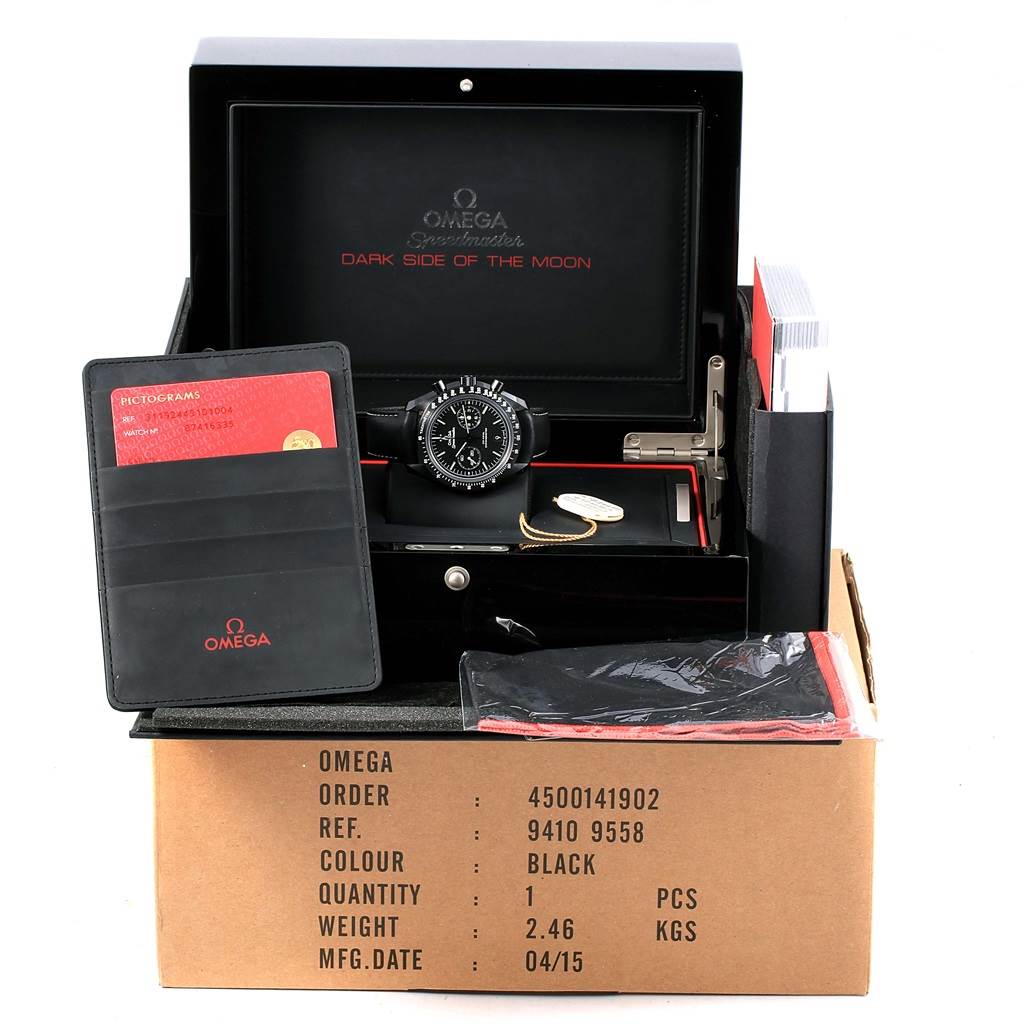 The image shows an Omega Speedmaster 311.92.44.51.01.004 Men
s Stainless Steel Black Dial 311.92.44.51.01.004 Men
s Stainless Steel Black Dial "Dark Side of the Moon" watch with its packaging, accessories, and documents.