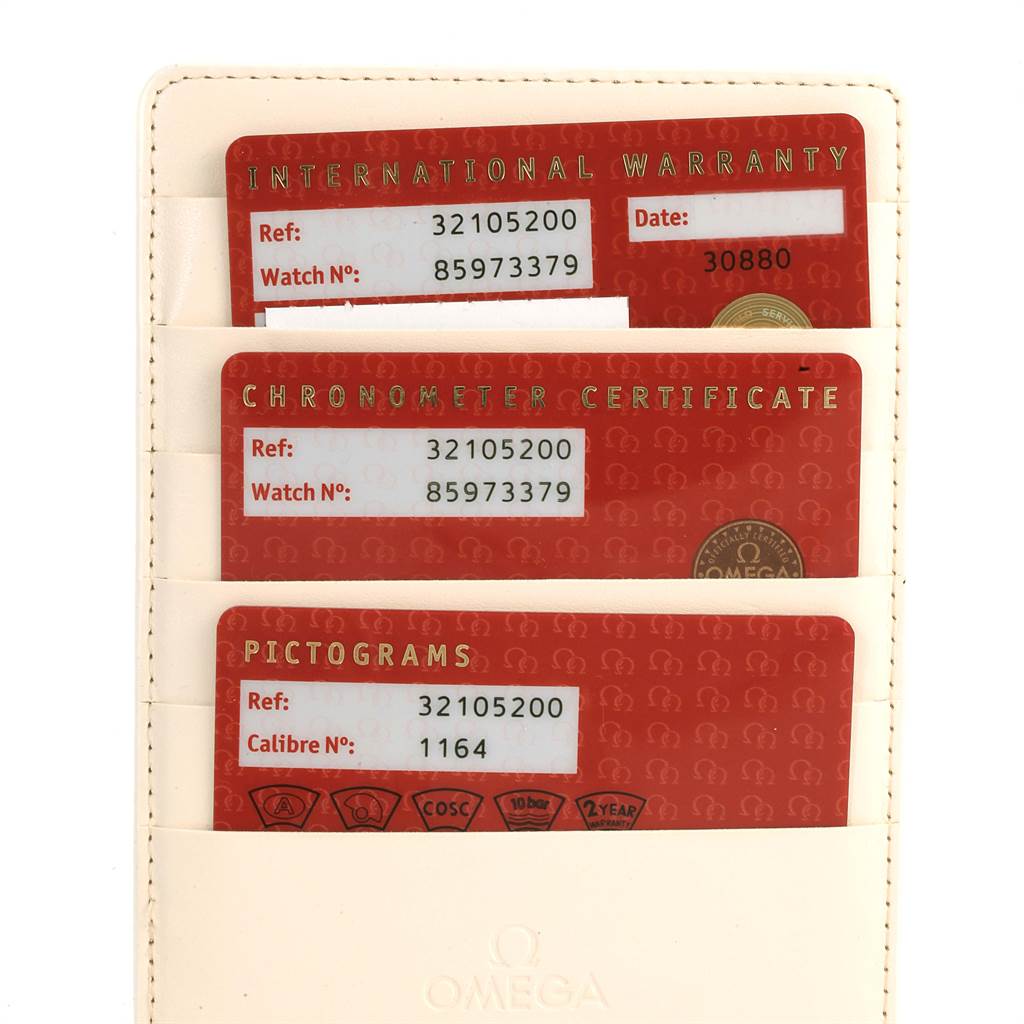 The image shows three warranty and certification cards for an Omega Speedmaster 3210.52.00 Men
s Stainless Steel Black Dial 3210.52.00 Men
s Stainless Steel Black Dial, held vertically in a white leather cardholder.