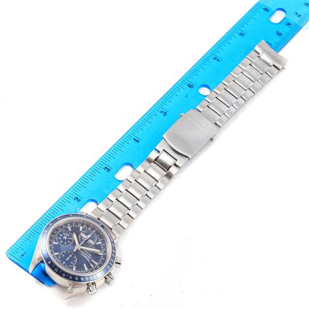 The image shows an Omega Speedmaster 3222.80.00 Men
s Stainless Steel Blue Dial 3222.80.00 Men
s Stainless Steel Blue Dial watch laid flat next to a blue ruler, highlighting its face and bracelet.