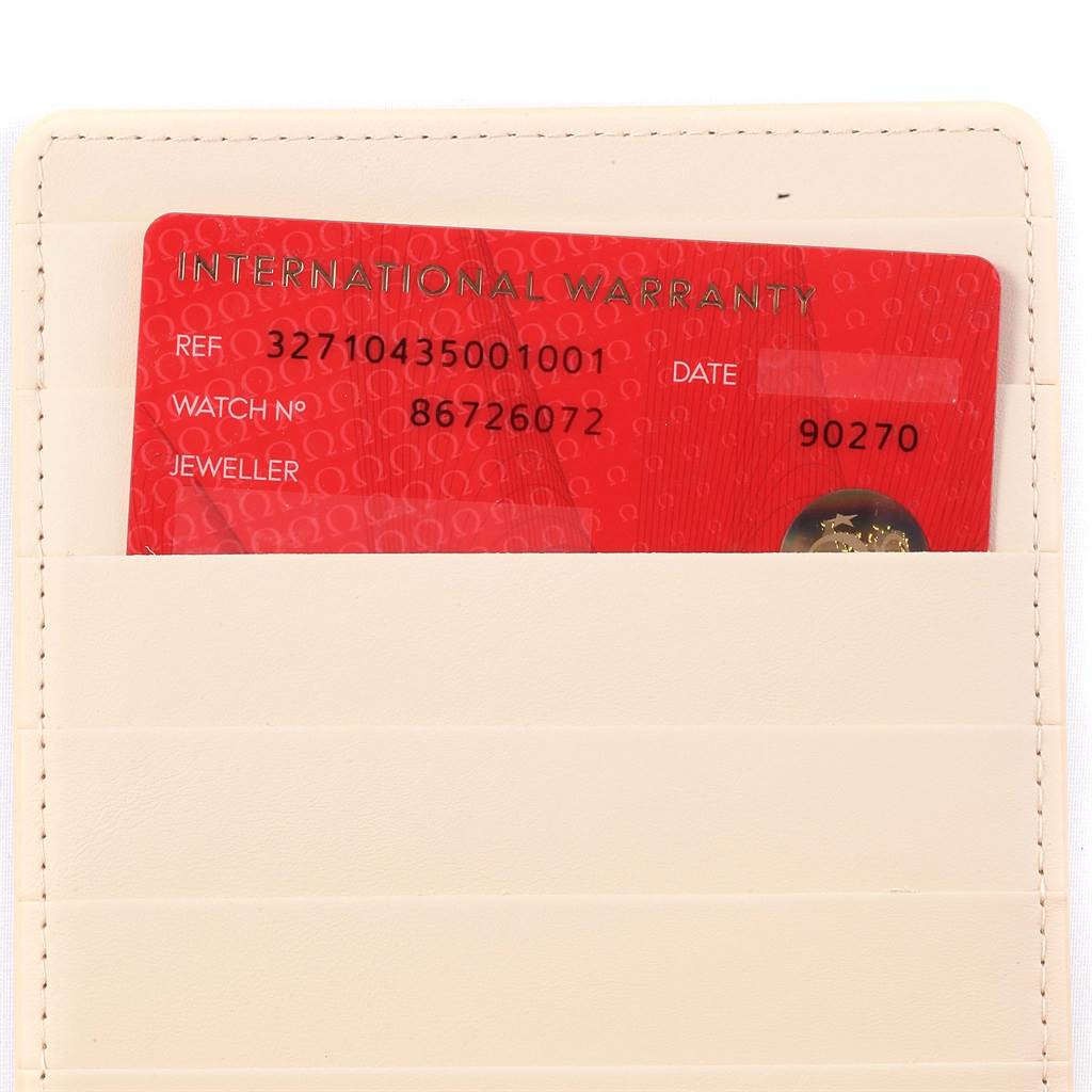 This image shows an International Warranty card for the Omega Speedmaster 327.10.43.50.01.001 Men's Stainless Steel Black Dial 327.10.43.50.01.001 Men's Stainless Steel Black Dial watch, partially inserted in a beige cardholder.