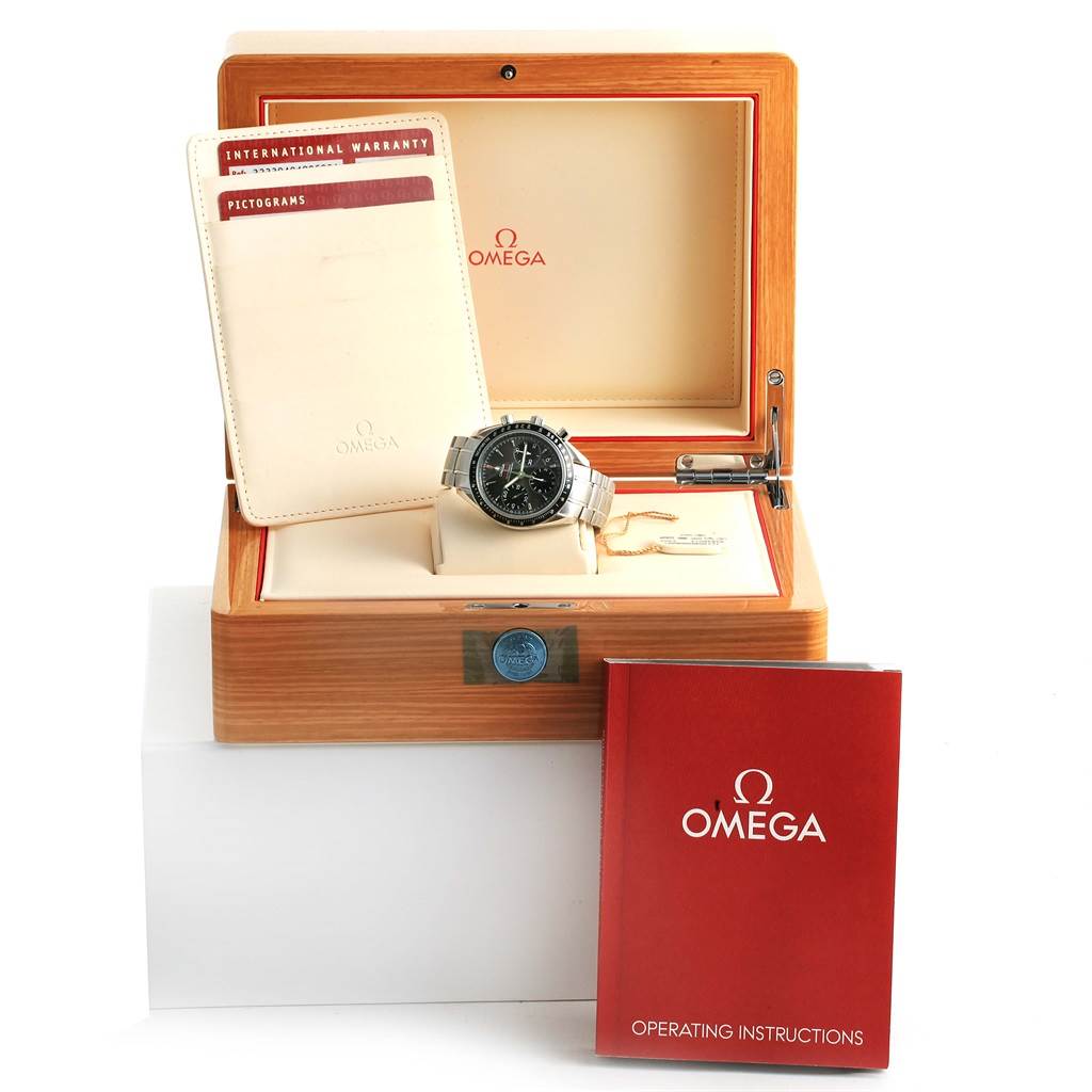 The image shows an Omega Speedmaster 323.30.40.40.06.001 Men's Stainless Steel Grey Dial 323.30.40.40.06.001 Men's Stainless Steel Grey Dial watch in its open wooden box with warranty card and operating instructions booklet.