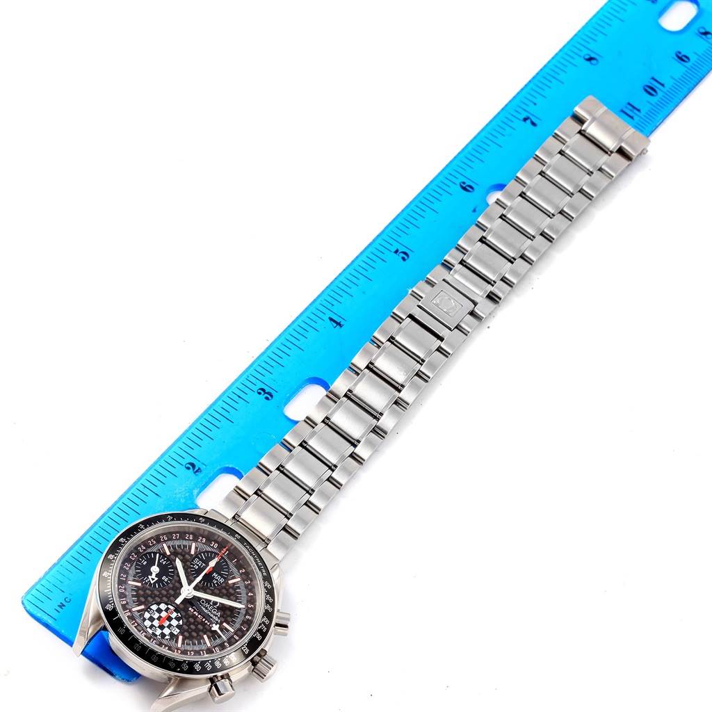 The image shows an Omega Speedmaster 3529.50.00 Men's Stainless Steel Black Dial 3529.50.00 Men's Stainless Steel Black Dial watch with a stainless steel band next to a blue ruler for scale.