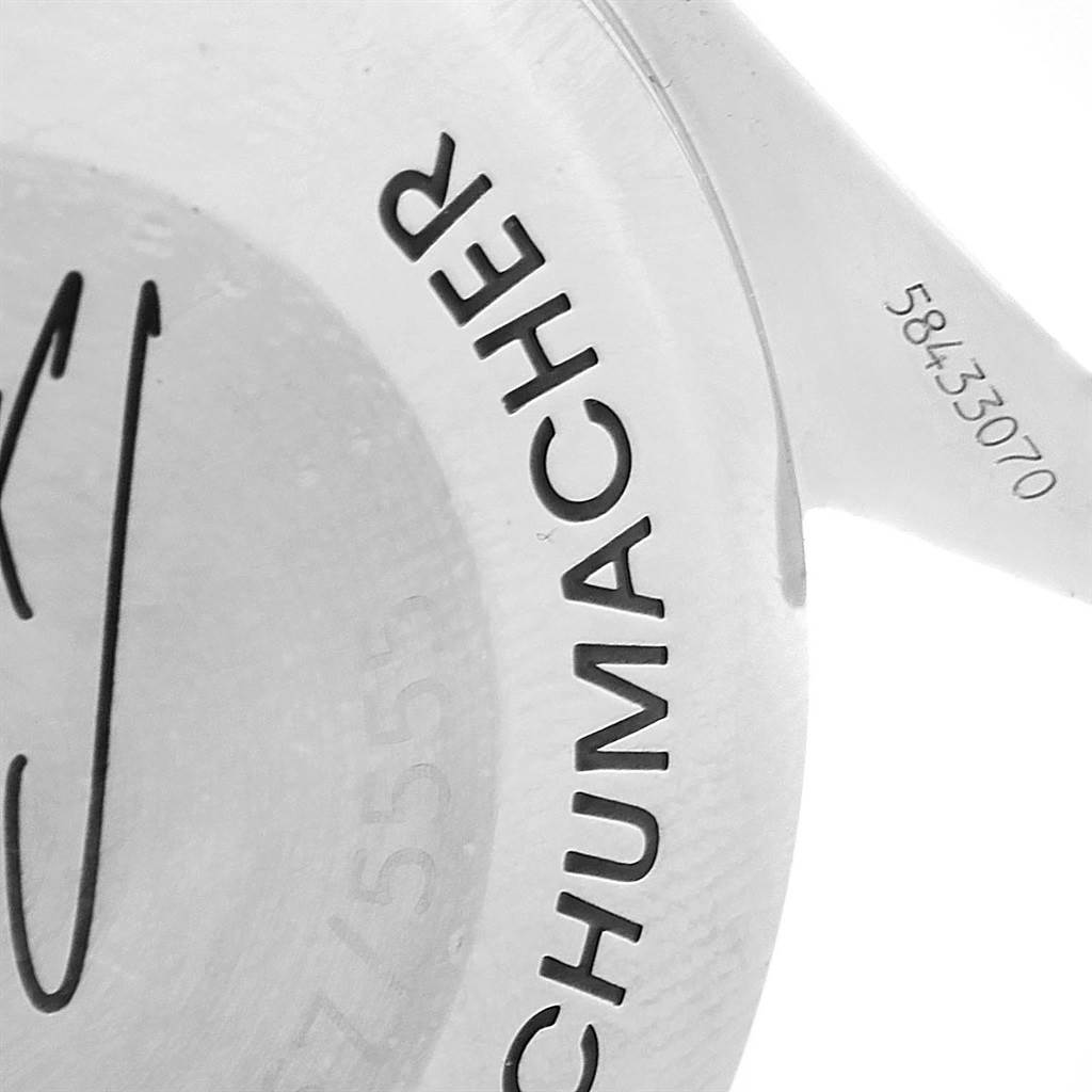 The image shows a close-up of the case back of an Omega Speedmaster 3529.50.00 Men's Stainless Steel Black Dial 3529.50.00 Men's Stainless Steel Black Dial, featuring part of the word "SCHUMACHER" and serial number.