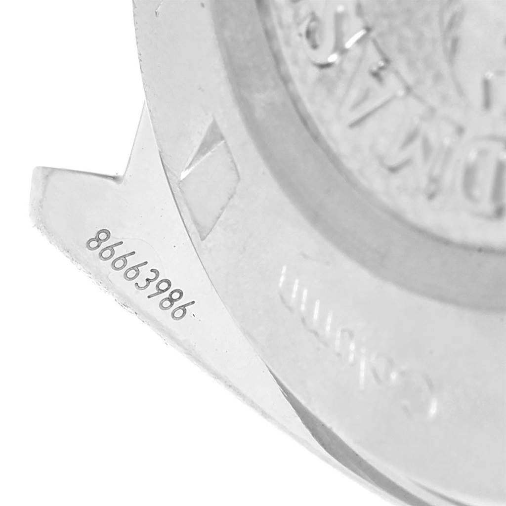 This close-up image shows the serial number and part of the case back of the Omega Speedmaster 327.10.43.50.06.001 Men
s Stainless Steel Grey Dial 327.10.43.50.06.001 Men
s Stainless Steel Grey Dial watch.