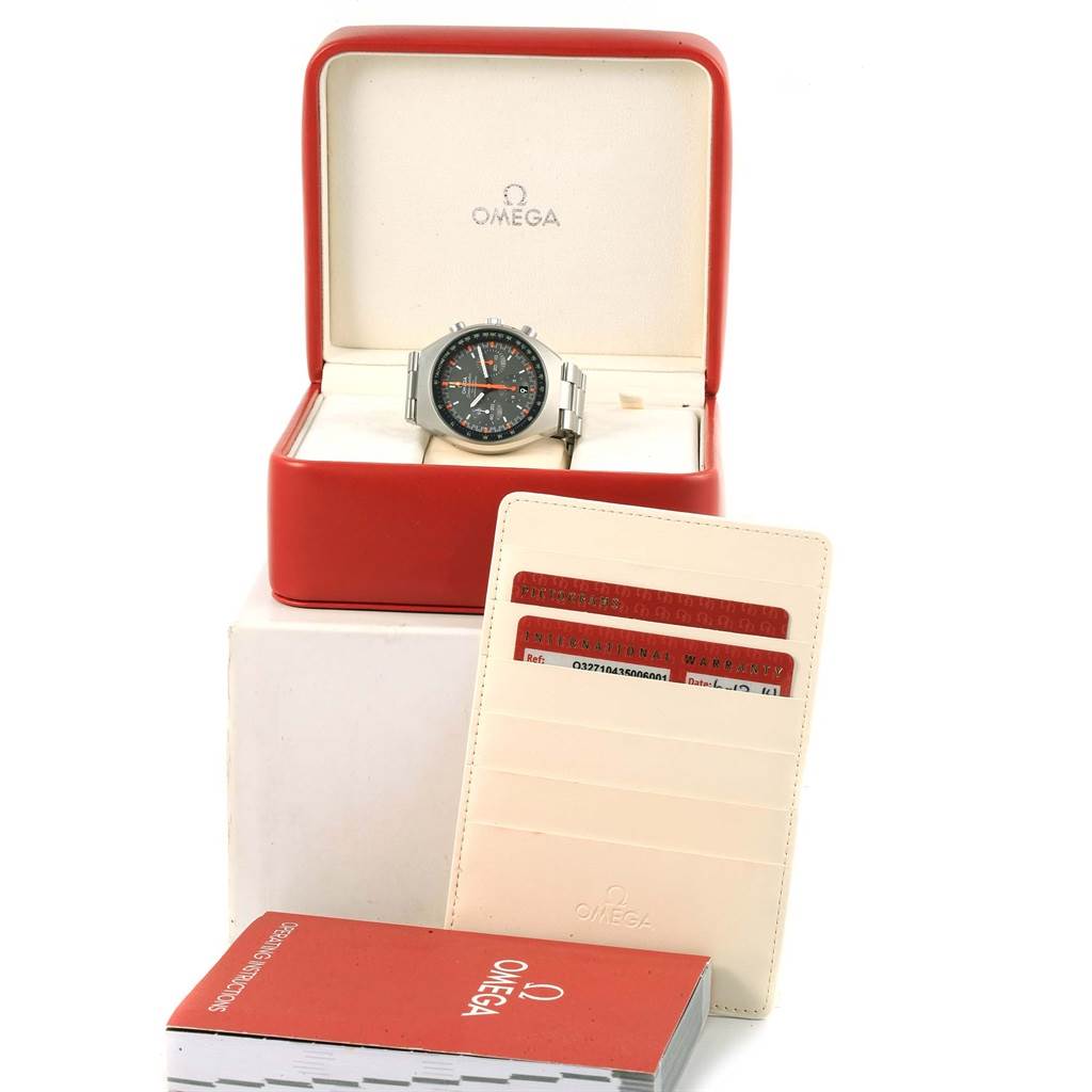 The image shows an Omega Speedmaster 327.10.43.50.06.001 Men
s Stainless Steel Grey Dial 327.10.43.50.06.001 Men
s Stainless Steel Grey Dial watch in a red box, accompanied by warranty cards and an Omega booklet.
