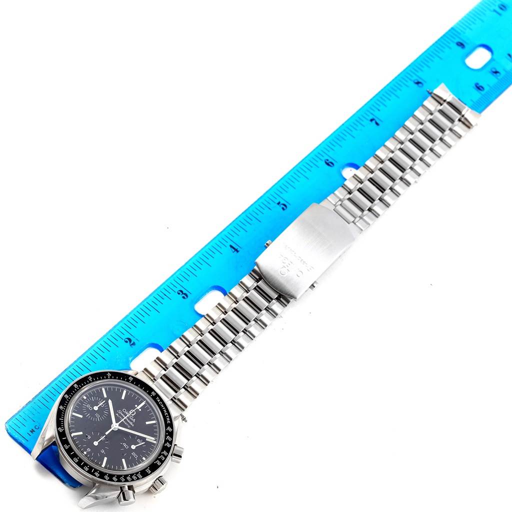 The image shows an Omega Speedmaster 3539.50.00 Men
s Stainless Steel Black Dial 3539.50.00 Men
s Stainless Steel Black Dial watch laid horizontally, with a ruler measuring the length of its bracelet.