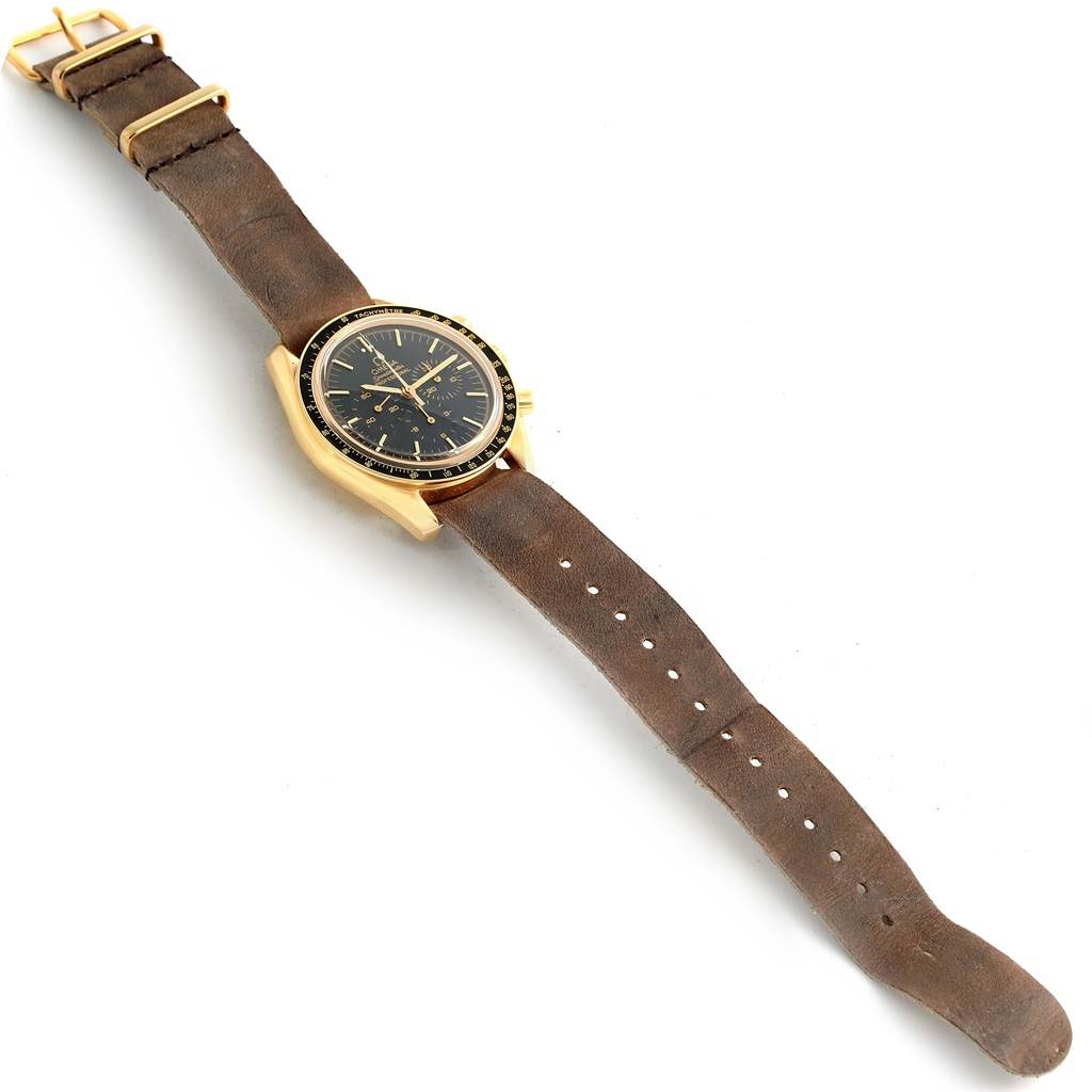 The image shows an Omega Speedmaster 3695.50.31 Men's Yellow Gold Black Dial 3695.50.31 Men's Yellow Gold Black Dial watch at an angle displaying both the face and brown leather strap.