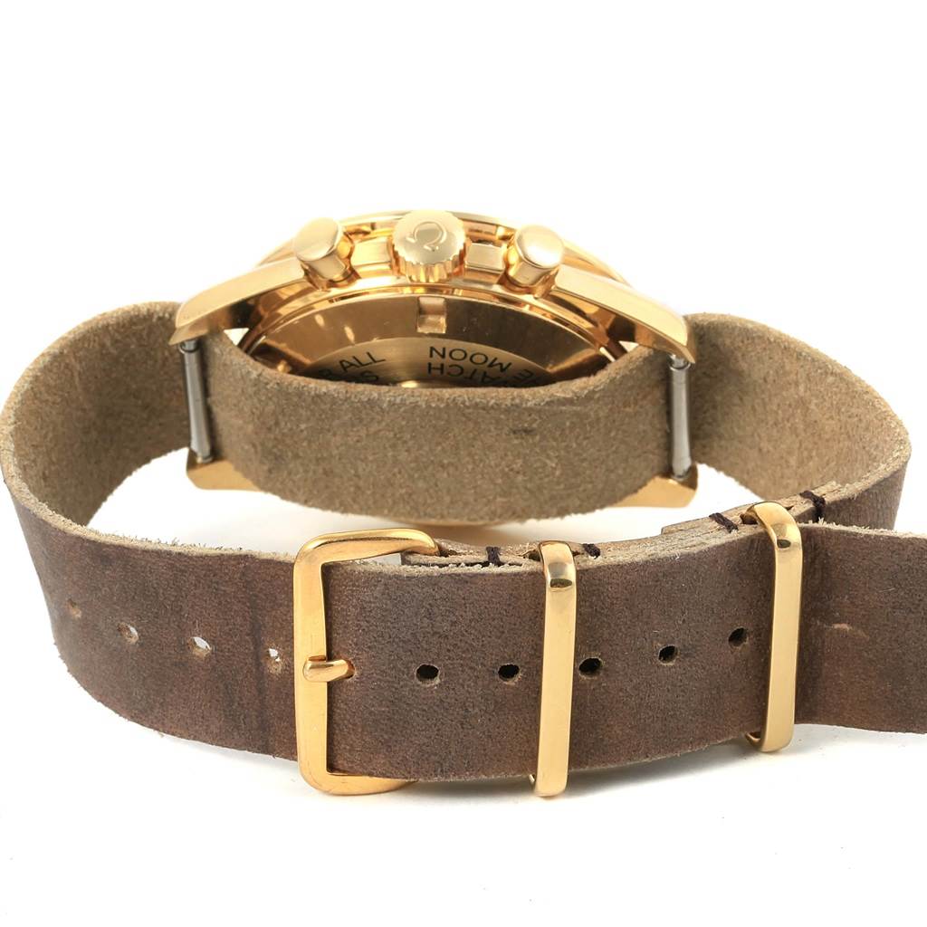 The image shows the back case and suede strap of an Omega Speedmaster 3695.50.31 Men's Yellow Gold Black Dial 3695.50.31 Men's Yellow Gold Black Dial watch from a rear angle.