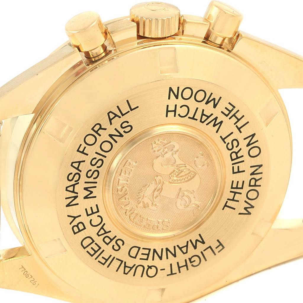 This image shows the back case of the Omega Speedmaster 3695.50.31 Men's Yellow Gold Black Dial 3695.50.31 Men's Yellow Gold Black Dial watch, taken at an angle highlighting the engraved text and pushers.