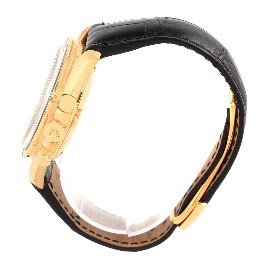 The Omega Speedmaster 3695.50.31 Men's Yellow Gold Black Dial 3695.50.31 Men's Yellow Gold Black Dial watch is shown from a side angle, displaying the gold case, black leather strap, and pushers.