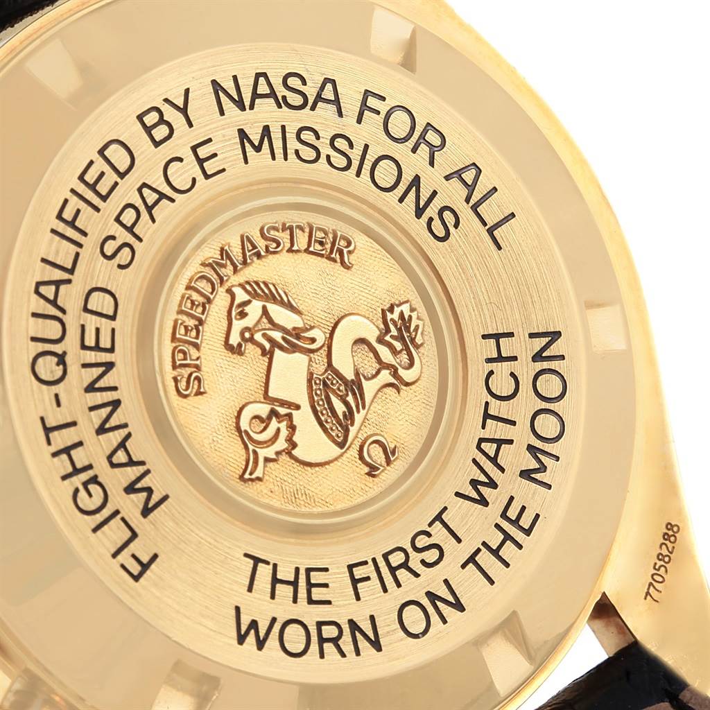 The image shows the case back of an Omega Speedmaster 3695.50.31 Men's Yellow Gold Black Dial 3695.50.31 Men's Yellow Gold Black Dial watch with its engraved text and emblem.