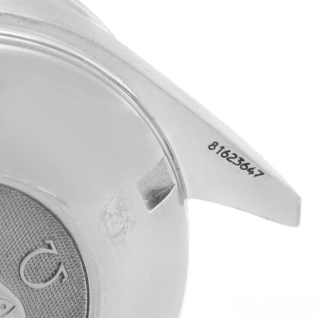 The image shows the partial case back of an Omega Speedmaster 3210.52.00 Men
s Stainless Steel Black Dial 3210.52.00 Men
s Stainless Steel Black Dial watch, focusing on the serial number engraving.