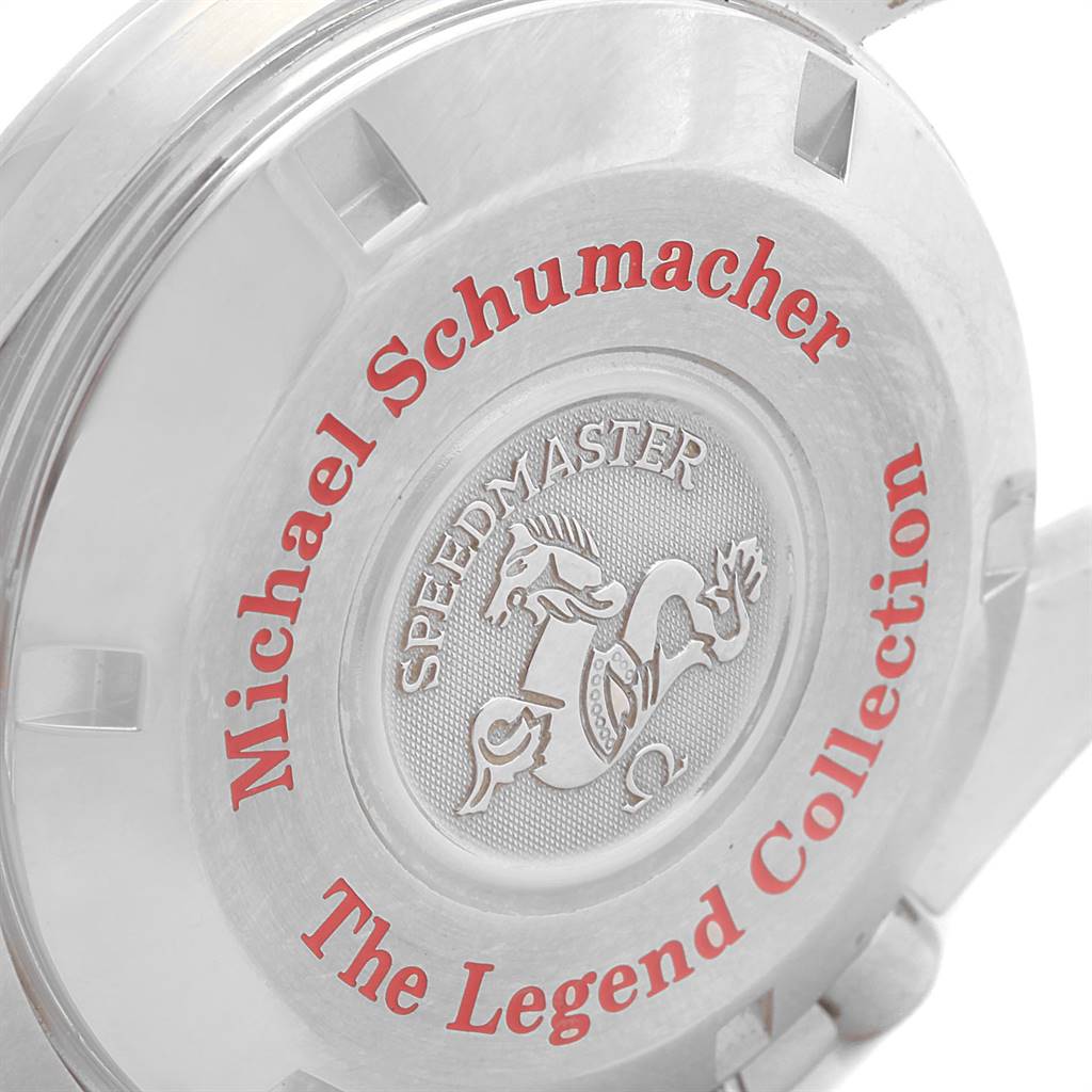 The image shows the case back of an Omega Speedmaster 3506.61.00 Men
s Stainless Steel Red Dial 3506.61.00 Men
s Stainless Steel Red Dial watch, featuring an engraved emblem and red text detailing "The Legend Collection."